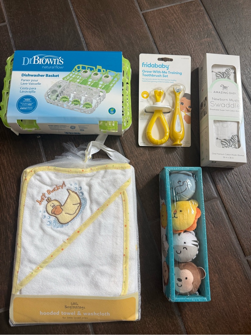 Baby Items- dishwasher basket, swaddle, hooded towel w/ cloth, toothbrush, & toy